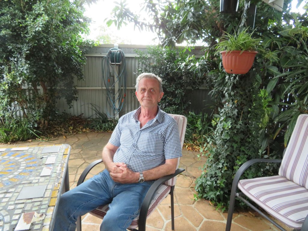 Despite having Dementia, John is able to receive services from Centacare so he can enjoy living at home. John is pictured smiling in his garden. 